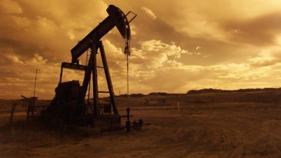 a photo of an onshore drilling rig on a cloudy day that is edited in sepia tones